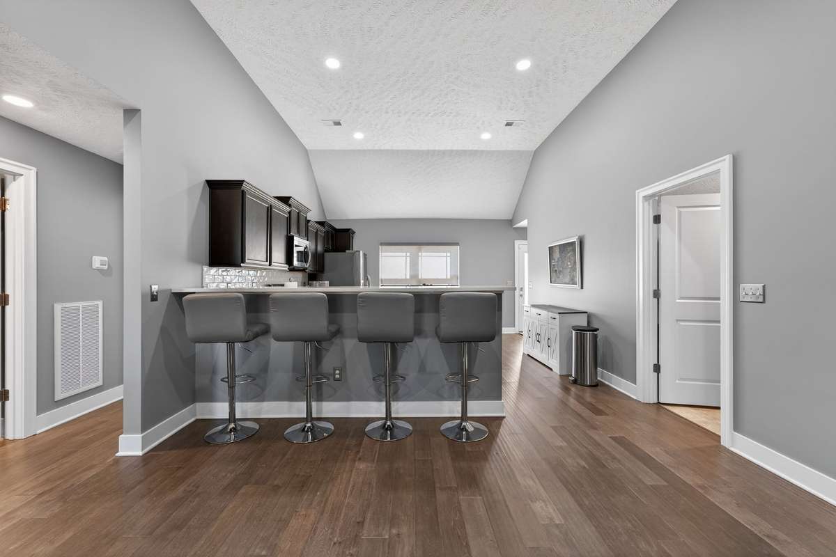 Four bar stools line the kitchen island, creating a natural spot for quick meals or keeping the cook company while dinner comes together.