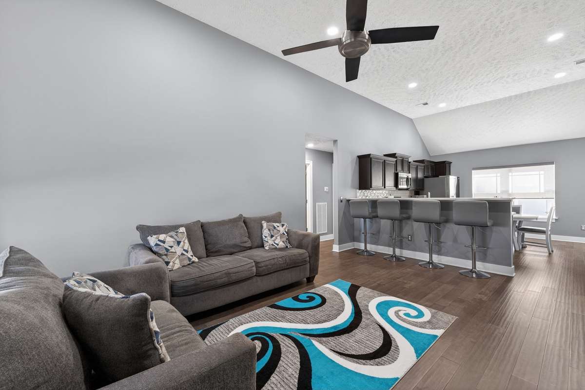 Open living room flows into the kitchen with bar seating that keeps conversation going between the two spaces.