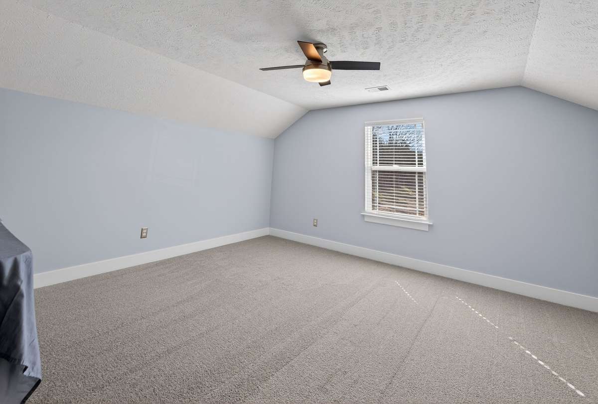 This upstairs bonus room feels separate from the main living areas, giving it a quiet retreat vibe perfect for winding down at the end of the day.