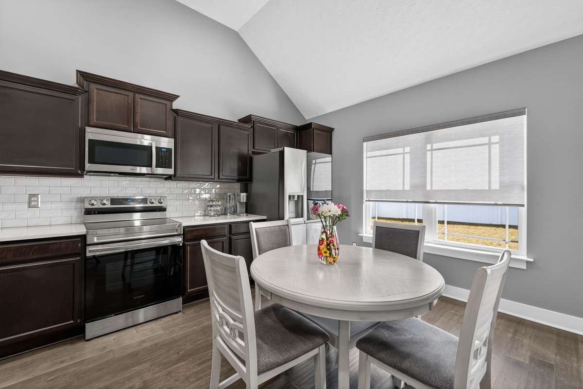 The eat-in nook keeps breakfast and casual meals separate from the main cooking area while still feeling connected to the kitchen.