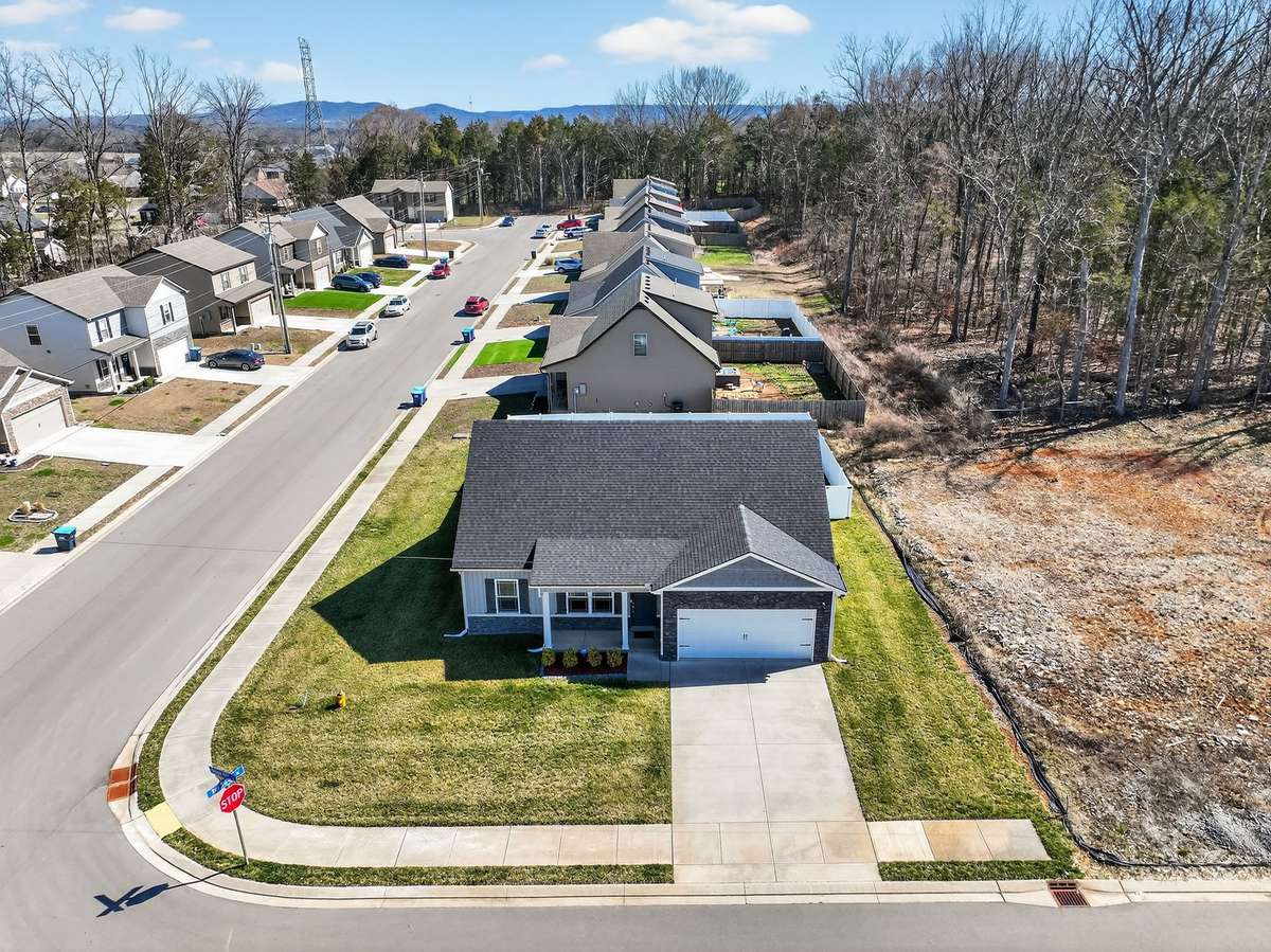 This corner lot home sits ready with everything already done — sodded yard, sprinkler system, and move-in condition throughout.