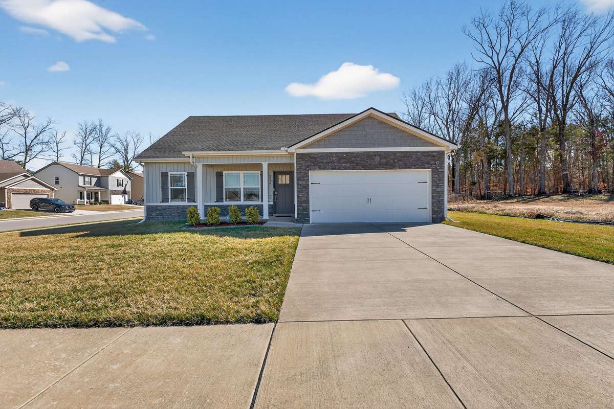 Welcome to 2216 Rolling Hills, Christiana, TN. Single-level ranch with a bonus room above the garage in Valley Farms with stone and siding exterior on a corner lot featuring a concrete driveway and open front yard.