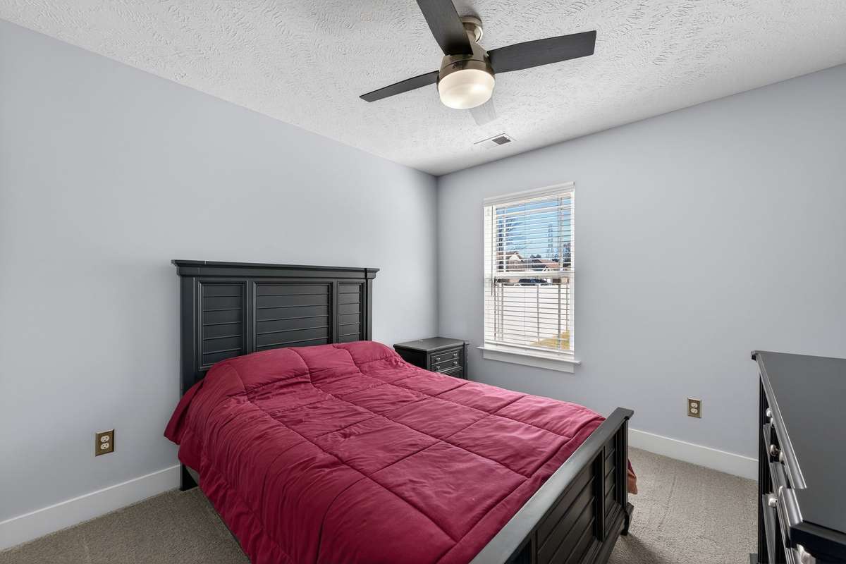 Secondary bedroom fits a full bed with room for a nightstand and dresser without feeling tight.