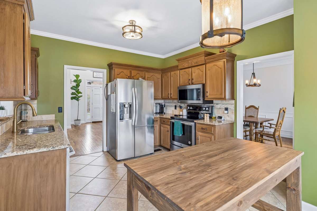 Functional kitchen layout featuring a double-basin sink, tile backsplash, and generous counter space for everyday cooking and prep! 1407 Ottawa Place, Murfreesboro, TN 37129