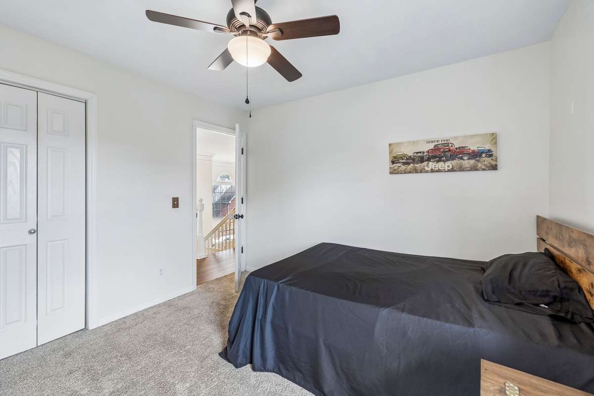 Bright secondary bedroom featuring plush carpeting, ceiling fan, and a double closet for plenty of storage! 1407 Ottawa Place, Murfreesboro, TN 37129