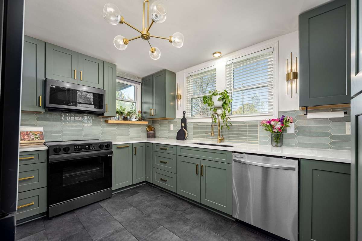 This kitchen has been completely remodeled with soft close cabinets, smart stainless appliances, tile floor and tile backsplash.