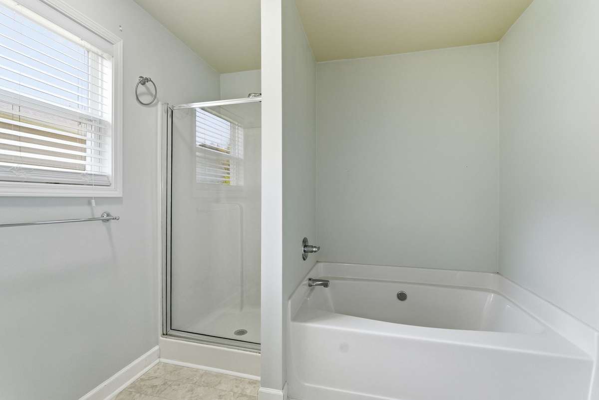 This primary bedroom suite has separate shower and separate tub.