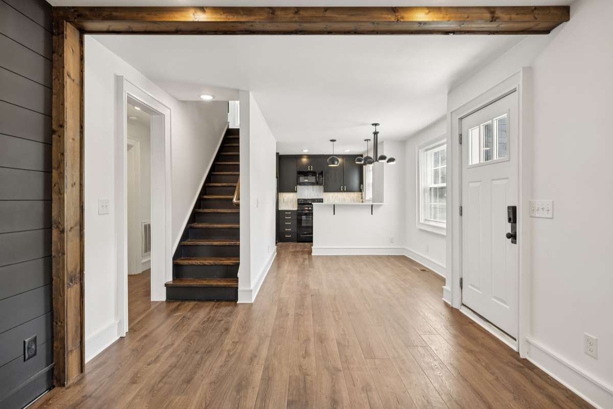 Front door opens into a welcoming living room, kitchen nook and kitchen.