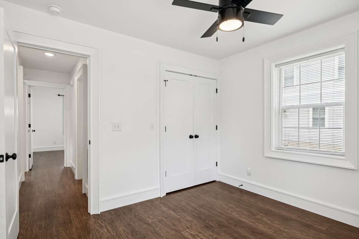 Second main level bedroom offering spacious closet with custom built-ins.