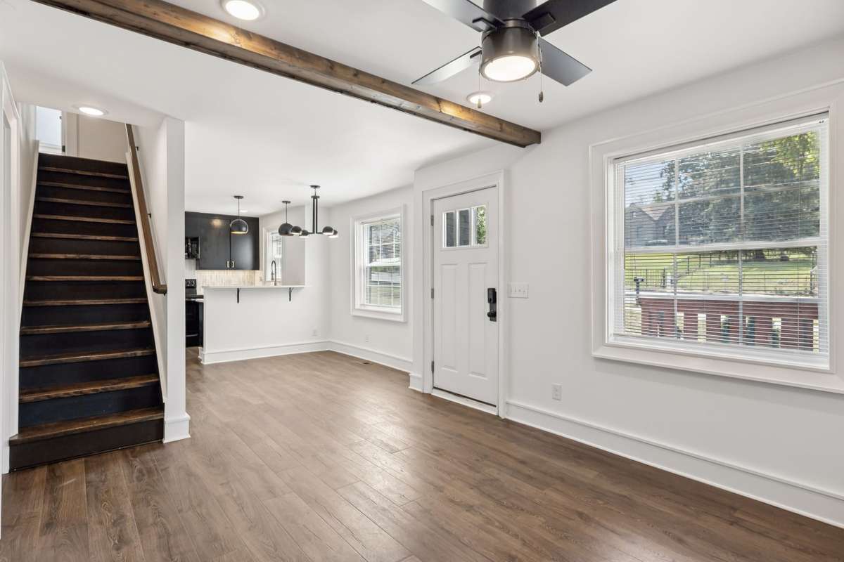 Stairs lead up to the primary bedroom, complemented by a dedicated washer and dryer nook.