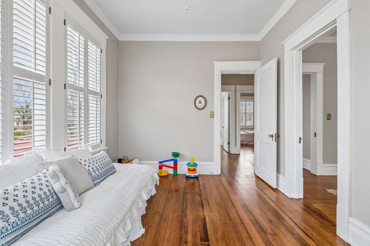 Another picture shows the right side of the upstairs back center hall and bath area