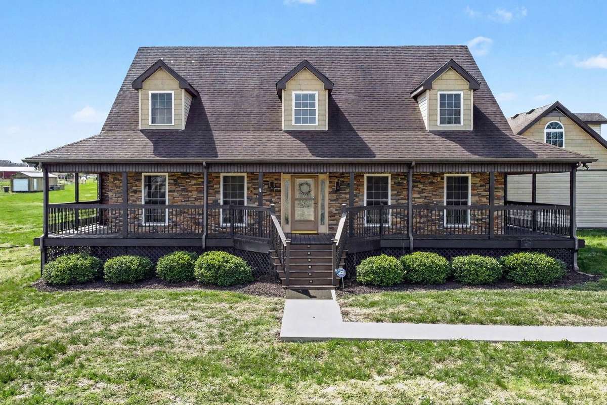 Relaxed Country Lifestyle Starts Right Here with this Beautiful Wrap-Around Porch