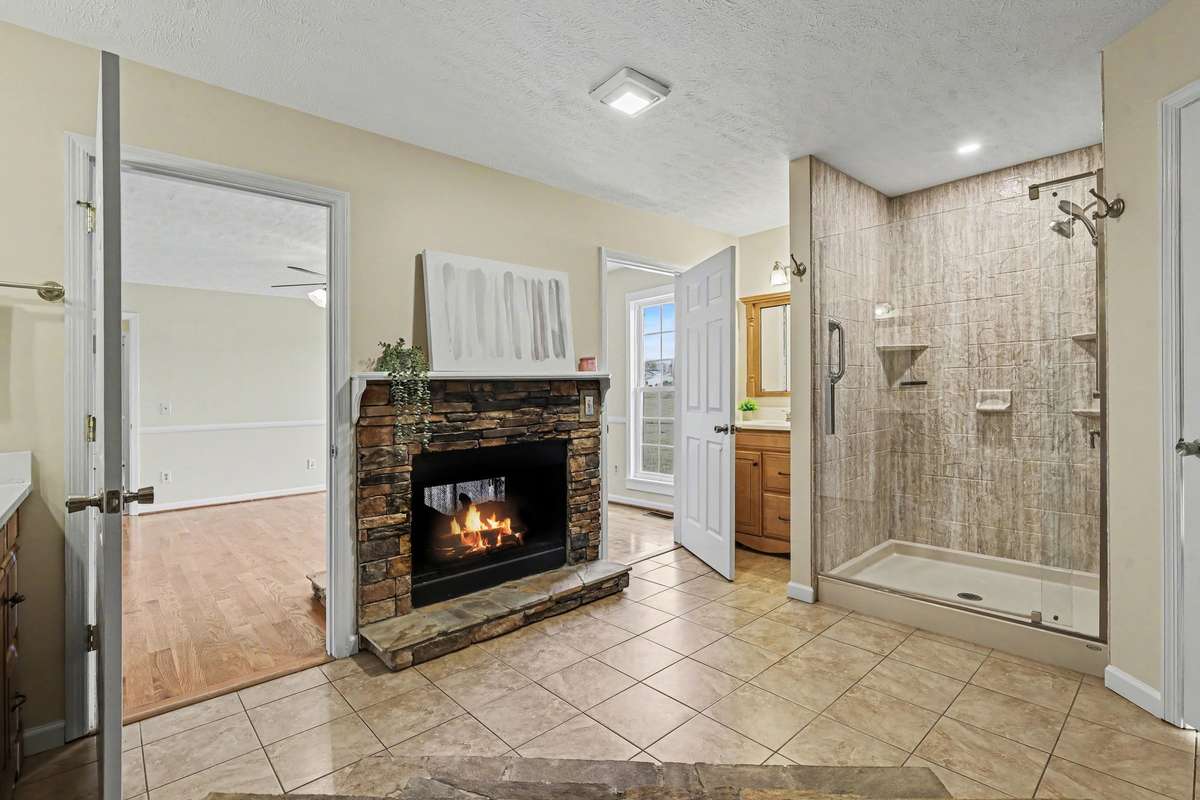 A Spa-Like Primary Ensuite Featuring A See-Through Fireplace Shared With The Bedroom—Perfect For Enjoying The Warm Glow While Relaxing In The Jacuzzi Tub