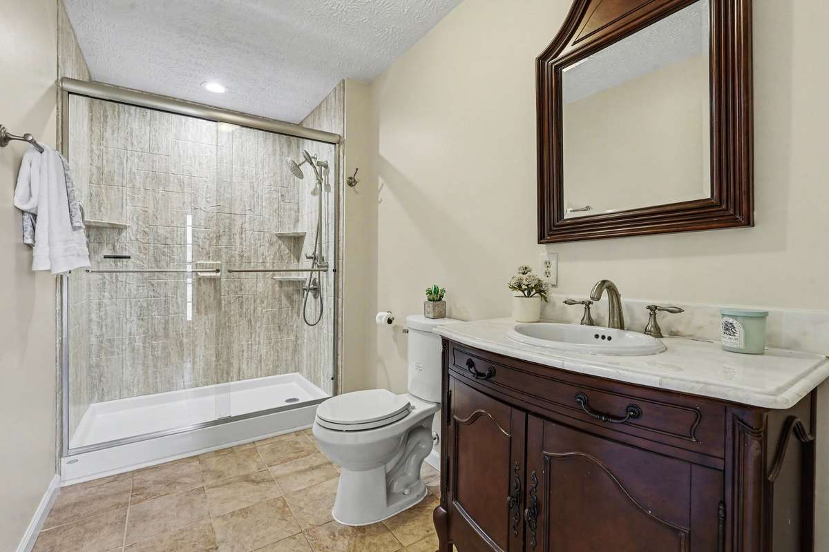 A Beautiful Lower-Level Guest Bathroom Conveniently Located Off The Front Entry—Perfect For Entertaining