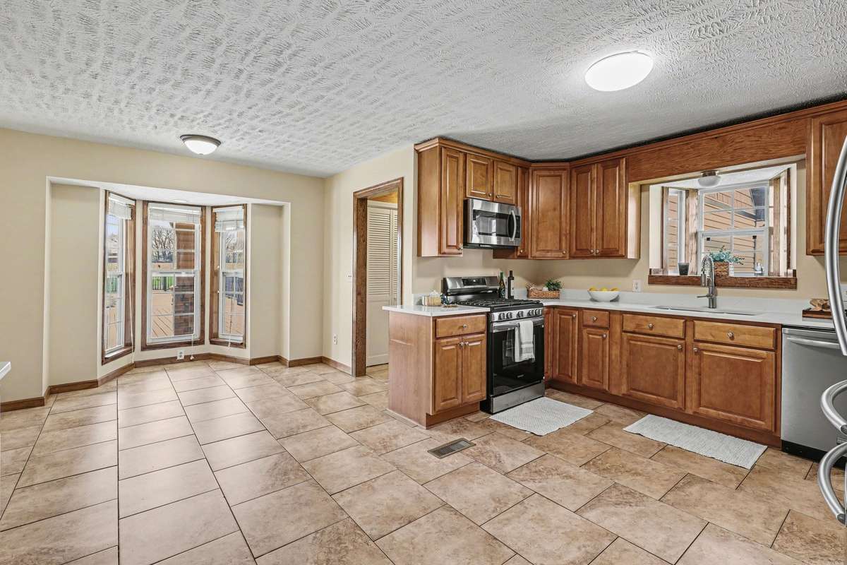 The Bright Eat-In Kitchen Features A Beautiful Bay Window Dining Area perfect for a Breakfast Nook