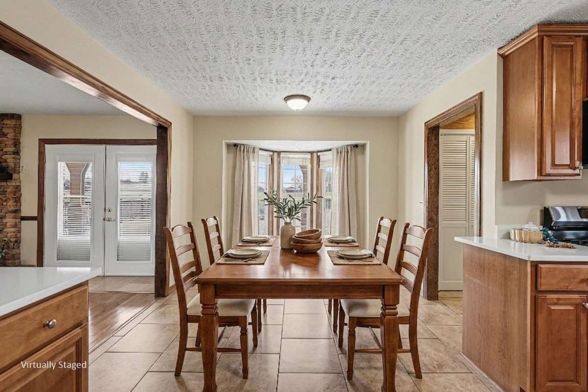 The Bright Eat-In Kitchen Features A Beautiful Bay Window Dining Area perfect for a Breakfast Nook *Virtually Staged