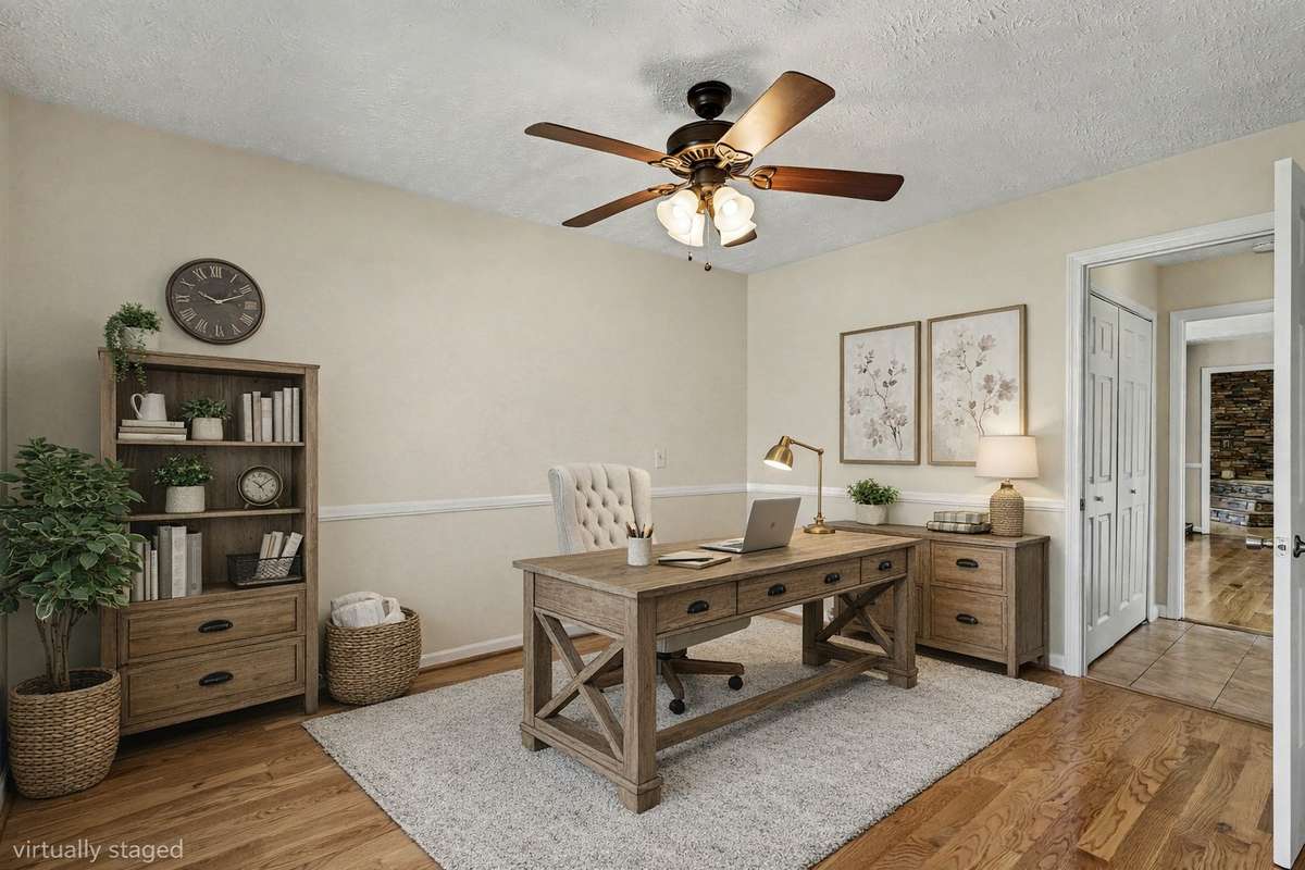 A Bright Home Office With Gleaming Hardwood Floors And Peaceful Front Yard Views—Perfect For Working From Home located on the Main Floor *Virtually Staged