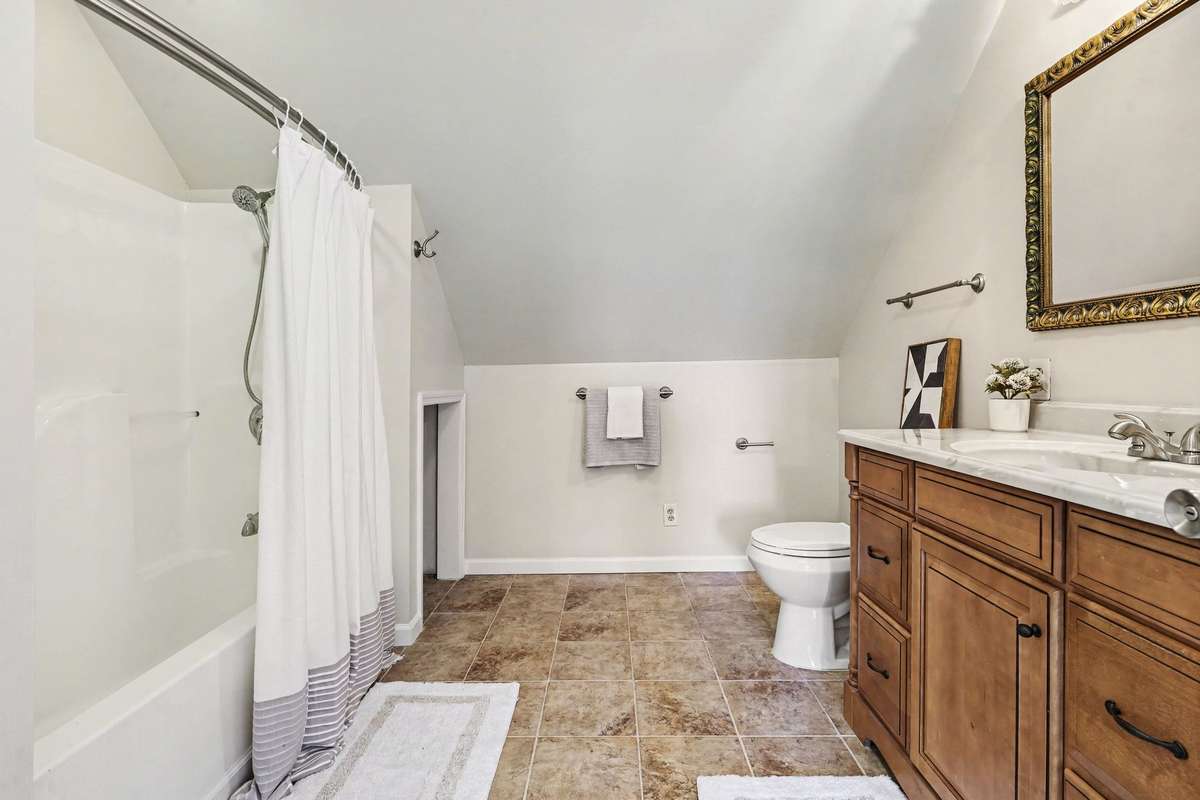 Another Exceptionally Large Private Full Bathroom With Spacious Vanity And Tub/Shower Serving Bedroom Three