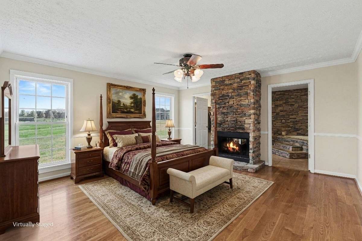 A Spacious Primary Suite Featuring A Cozy See-Through Fireplace And Spa-Like Ensuite With Stone Jacuzzi *Virtually Staged