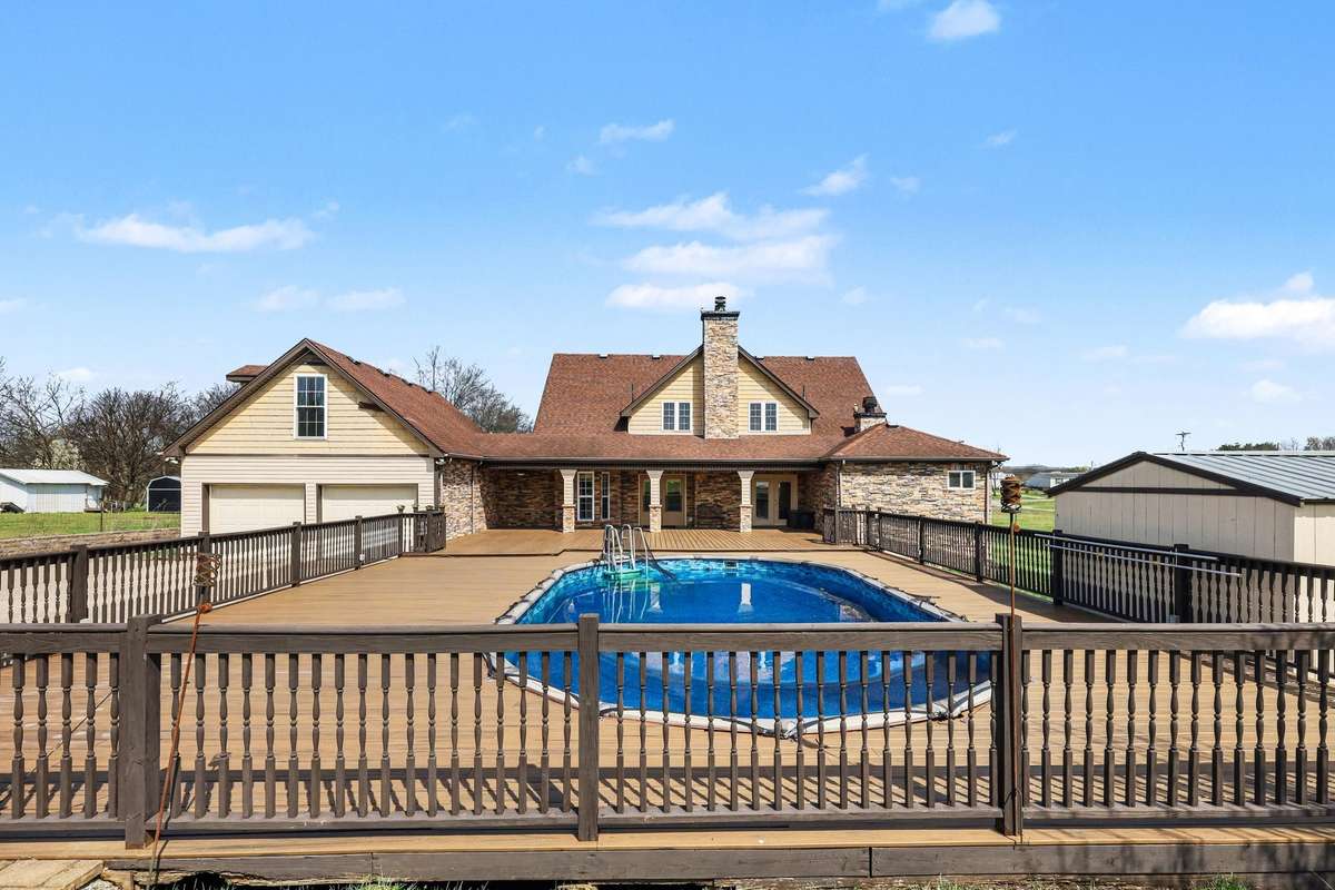 A Private Backyard Retreat Featuring A Spacious Deck Surrounding The Pool—Perfect For Entertaining And Relaxing