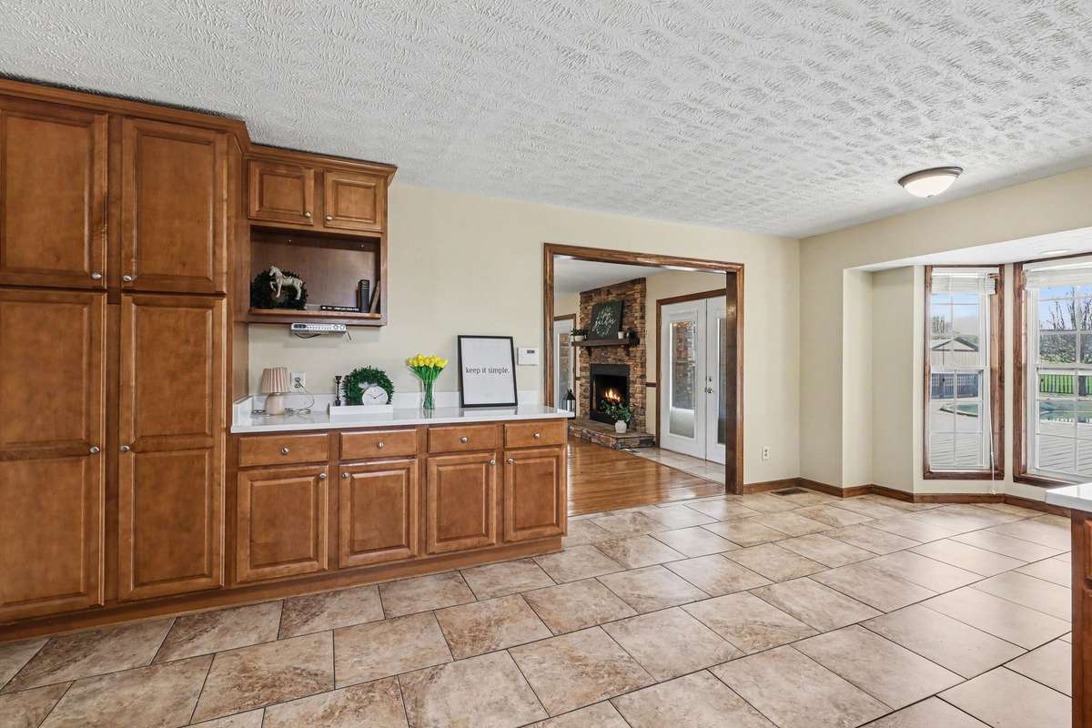 Additional Cabinetry And Counter Space With Easy Flow To The Living Room And Formal Dining Area