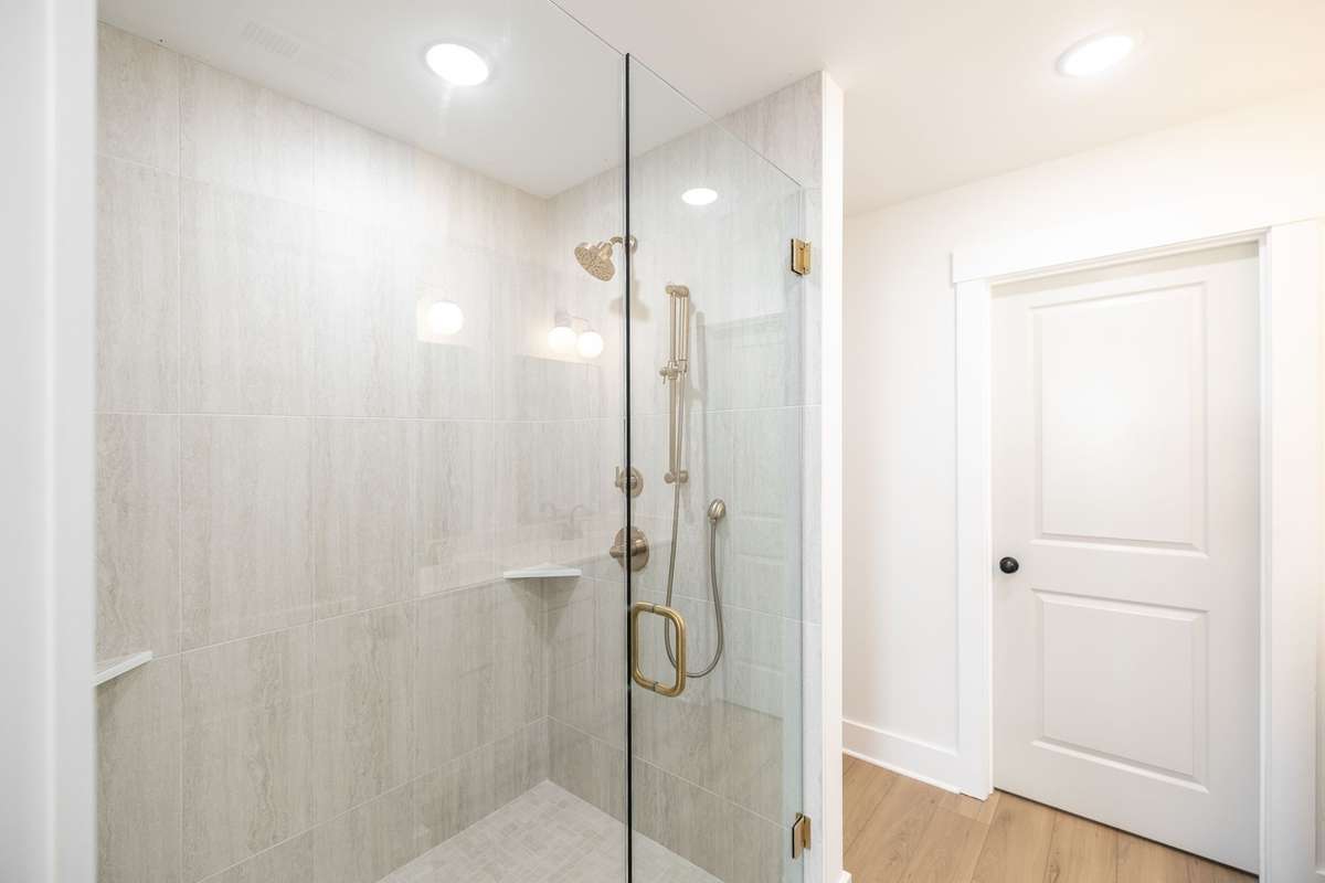 Large tile shower with glass door, upgraded champagne bronze faucet~