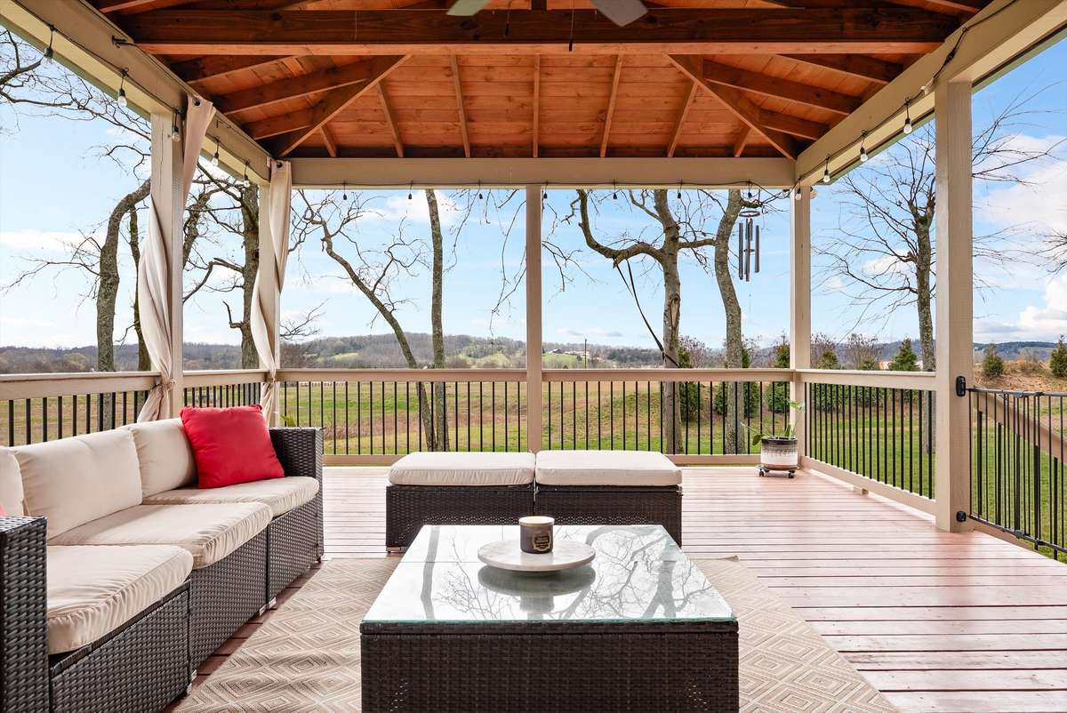 The current owners added this incredible covered outdoor living space, set on a 2” concrete pad beneath the deck—perfect for relaxing, entertaining, and enjoying the scenic views year-round.