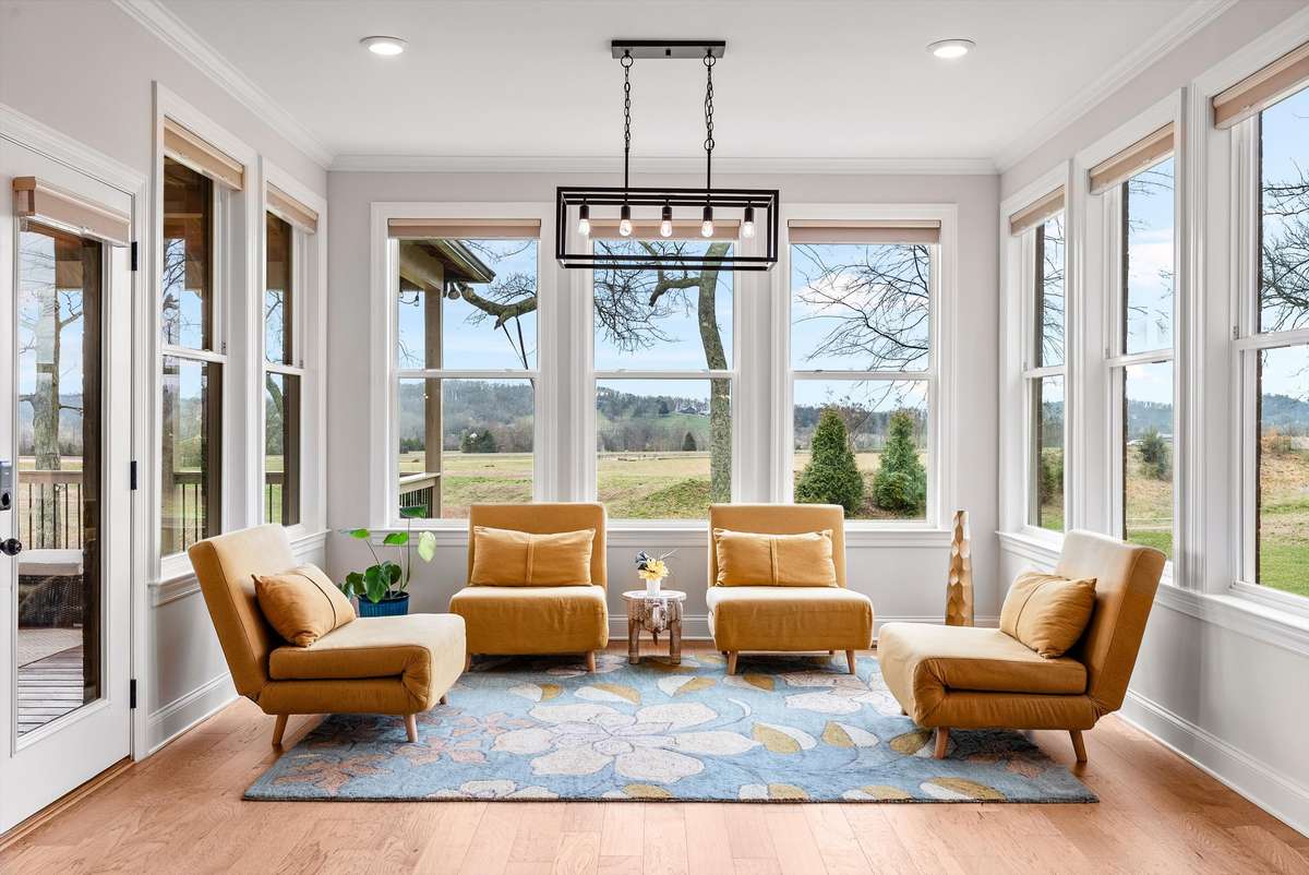 Inviting sunroom-style retreat with panoramic views, abundant natural light, and a cozy layout perfect for morning coffee or evening relaxation.