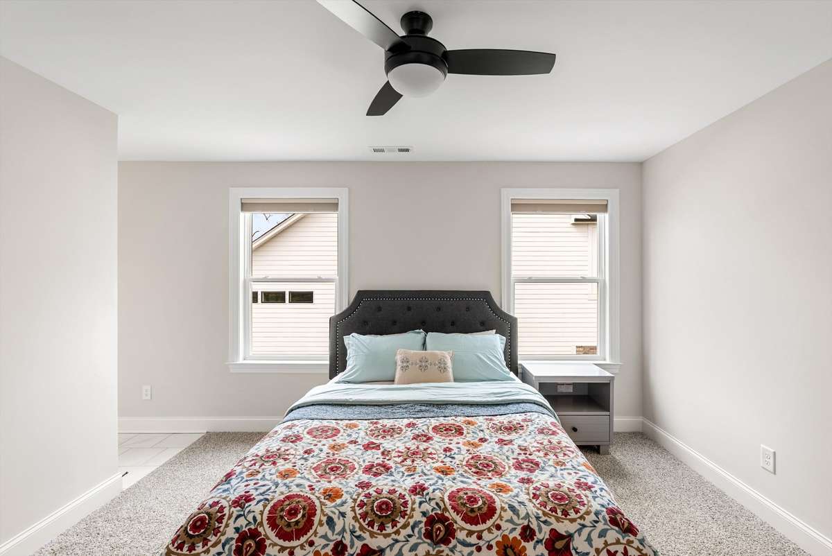 Comfortable secondary bedroom with balanced natural light, neutral finishes, and a versatile layout suited for a variety of needs.