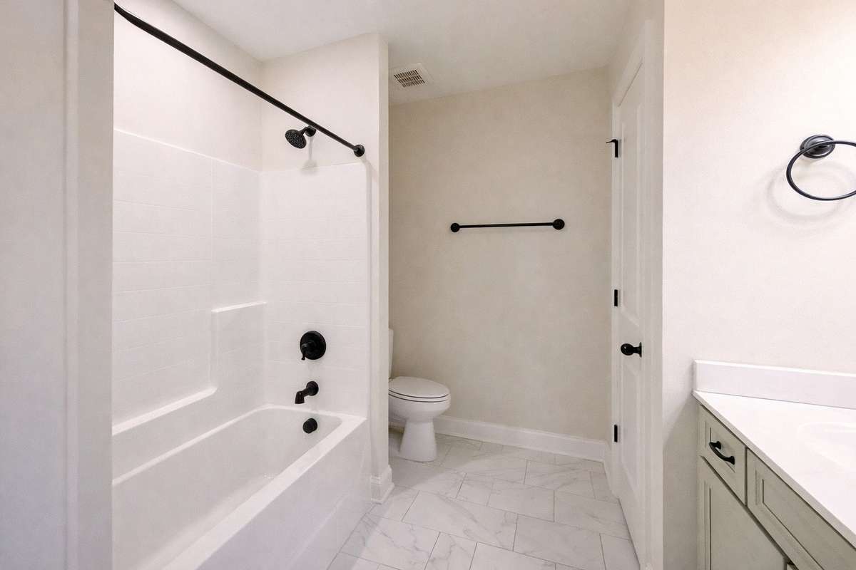 Well-appointed upstairs full bathroom featuring a clean, neutral design with tub/shower combo and modern fixtures—ideal for family or guests.