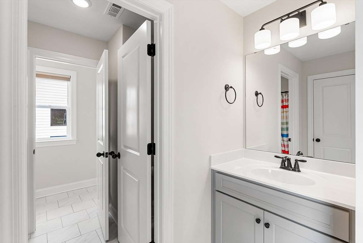 Clean and functional Jack n Jill bathroom with a bright vanity area and easy access to adjoining spaces—designed for everyday convenience.