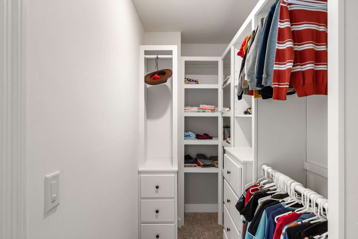 Every closet has been thoughtfully custom finished with built-in wooden cabinetry, offering organized storage and a clean, high-end feel throughout the home.