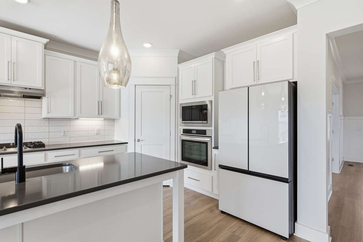 Plan your next chef dinner in this luxurious kitchen featuring a contemporary white Fridge