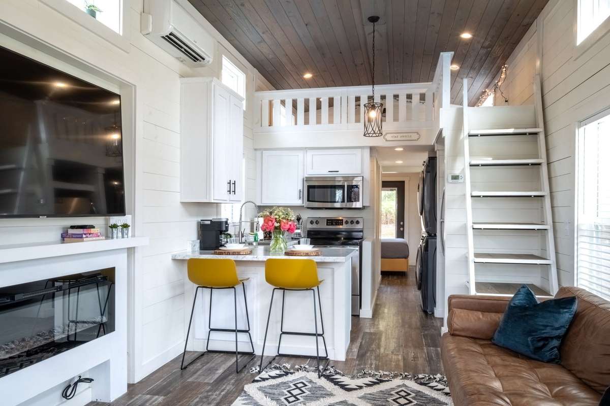 Cozy living room with a vaulted ceiling greets your as you come in the home through the screened-in porch