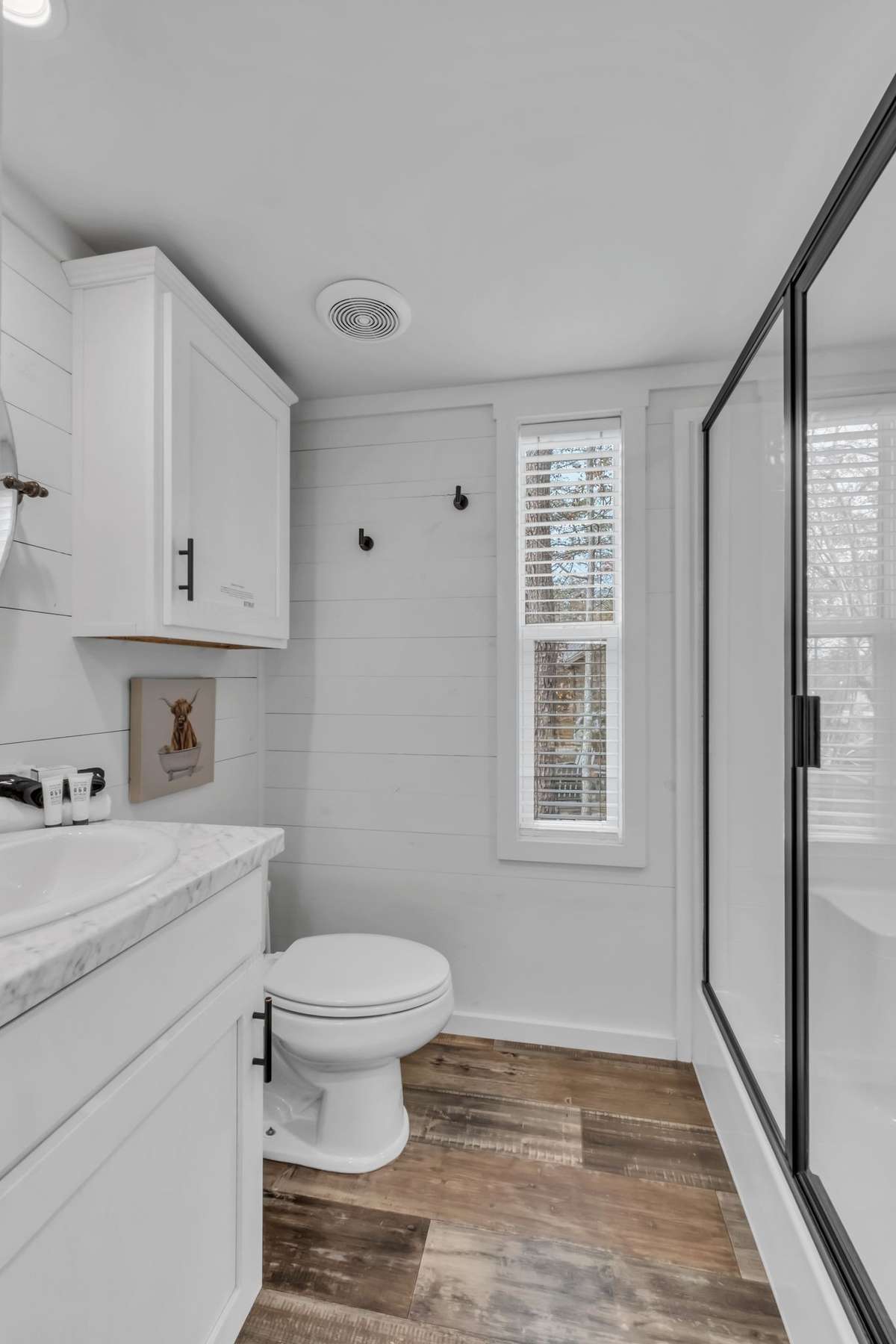 The bathroom is in the hallway across from the built-in bunks