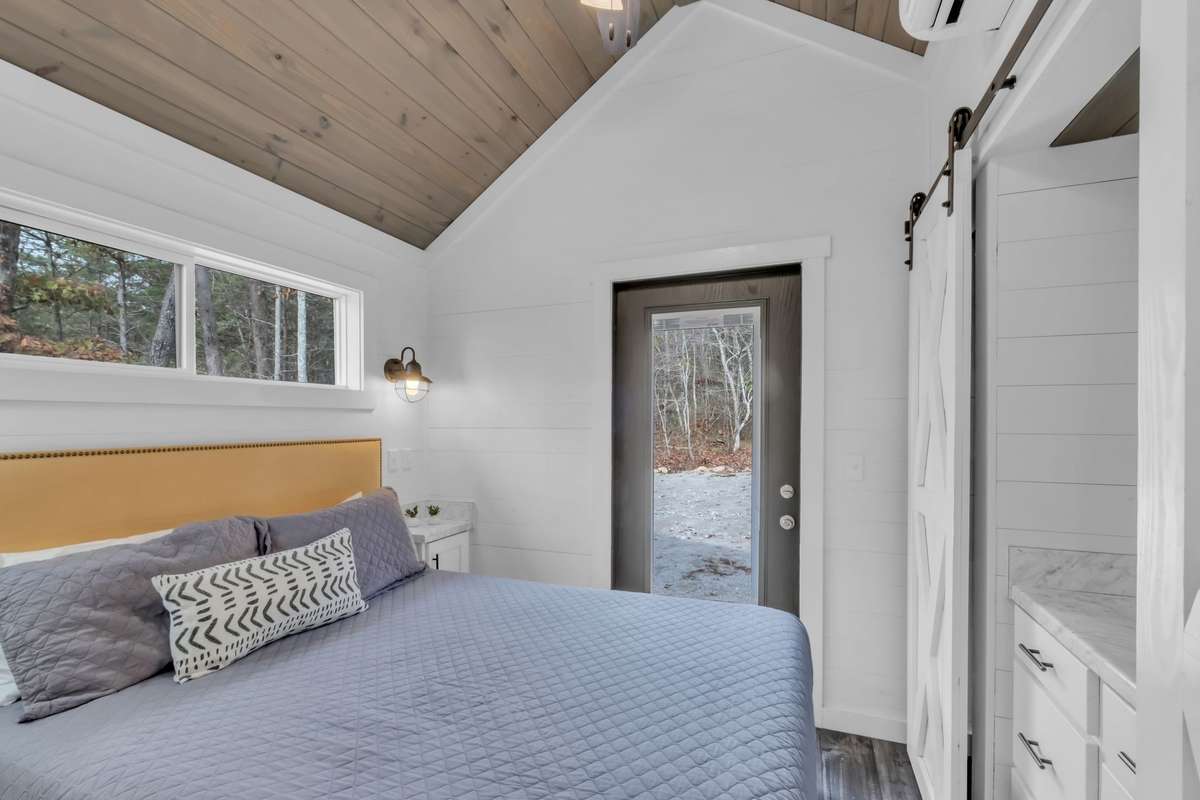 The primary bedroom has a vaulted ceiling, a ceiling fan, a mini split HVAC, 2 closets, a built-in dresser and is drenched in natural light!