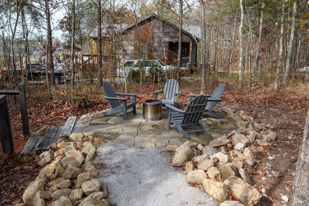 Cozy up by the fire pit that sits on a high point of the lot providing great lake views!