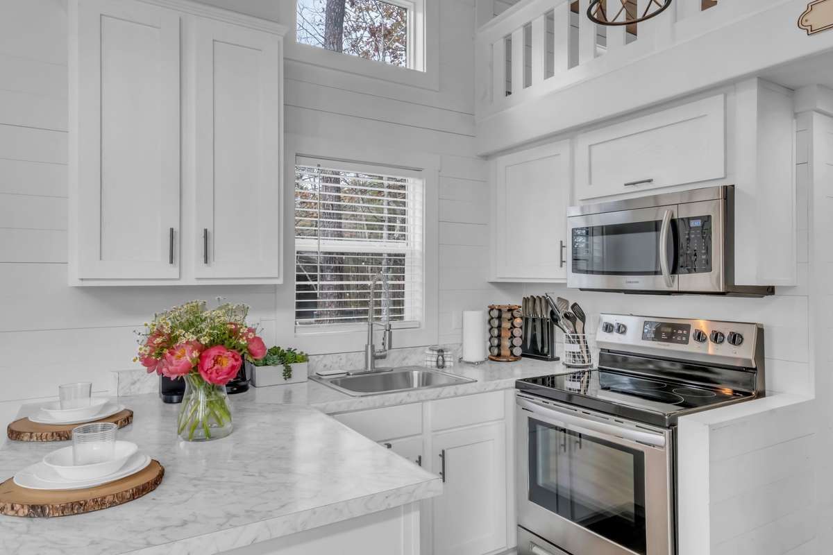 The crips kitchen comes with stainless steel appliances and has generous cabinet space that is proportionate with the home!