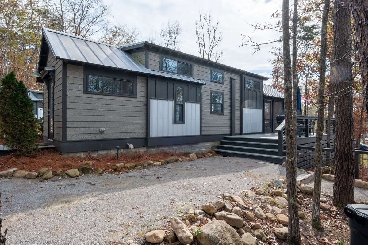 The generously sized lot has a long driveway that can accommodate 4 to 5 cars and there are 2 additional parking spaces at the top of the driveway near the house