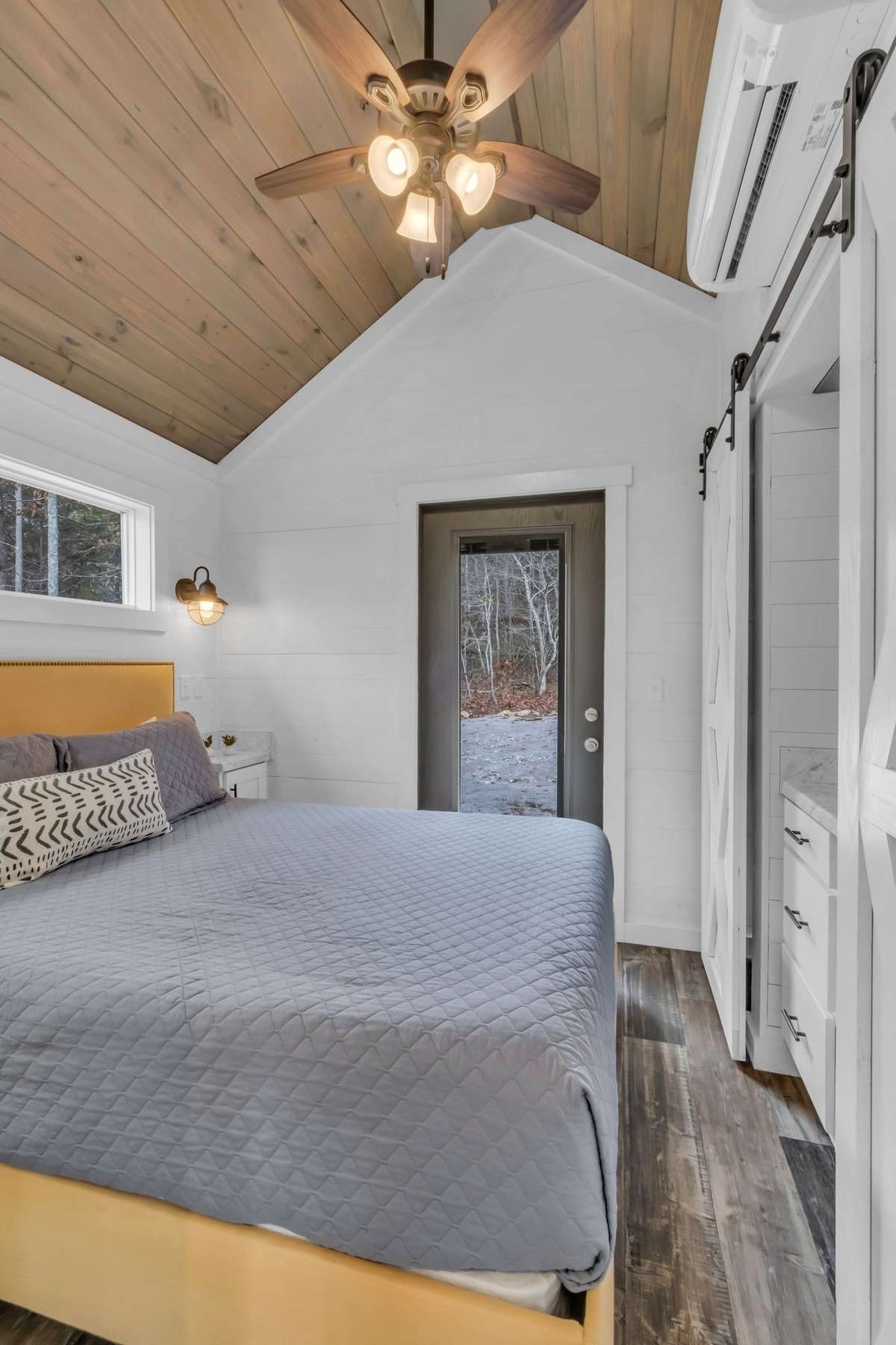 The bedroom has a door to access the back of the house