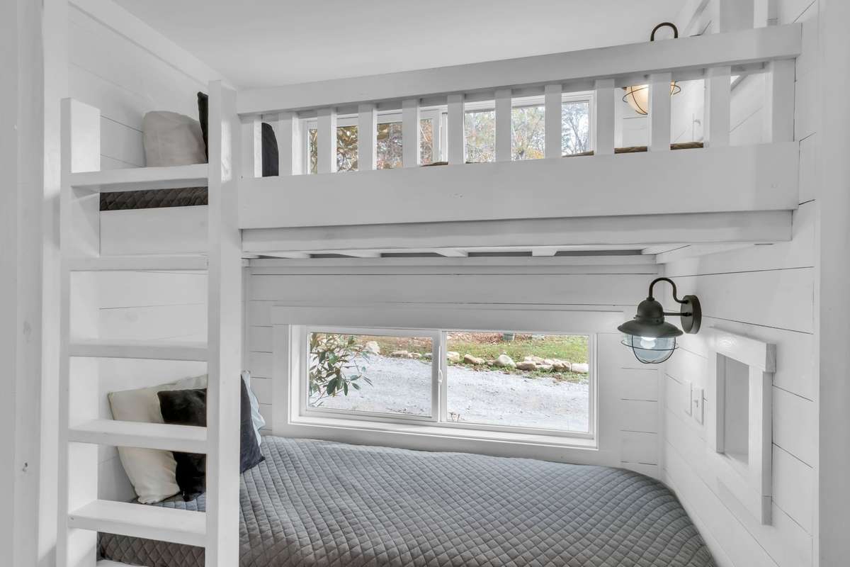 Built-in bunk beds situated between the kitchen and the bedroom