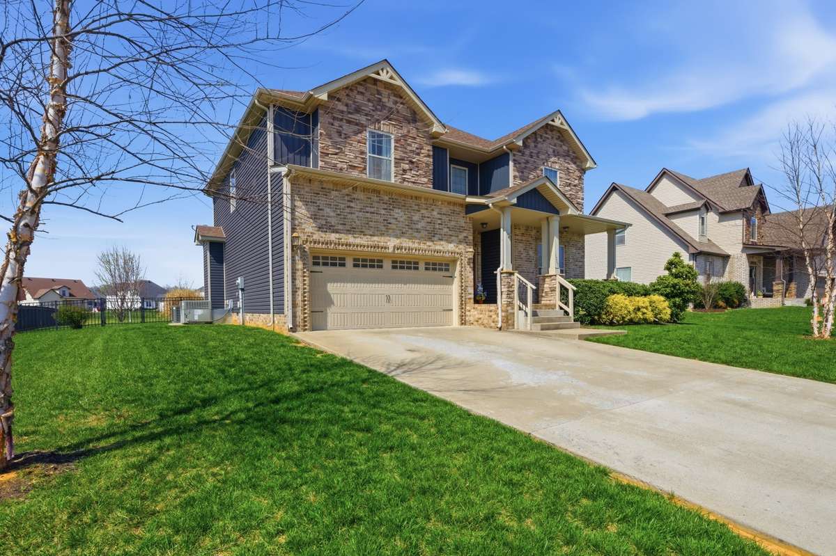 Front of house with beautiful landscaping and mature trees