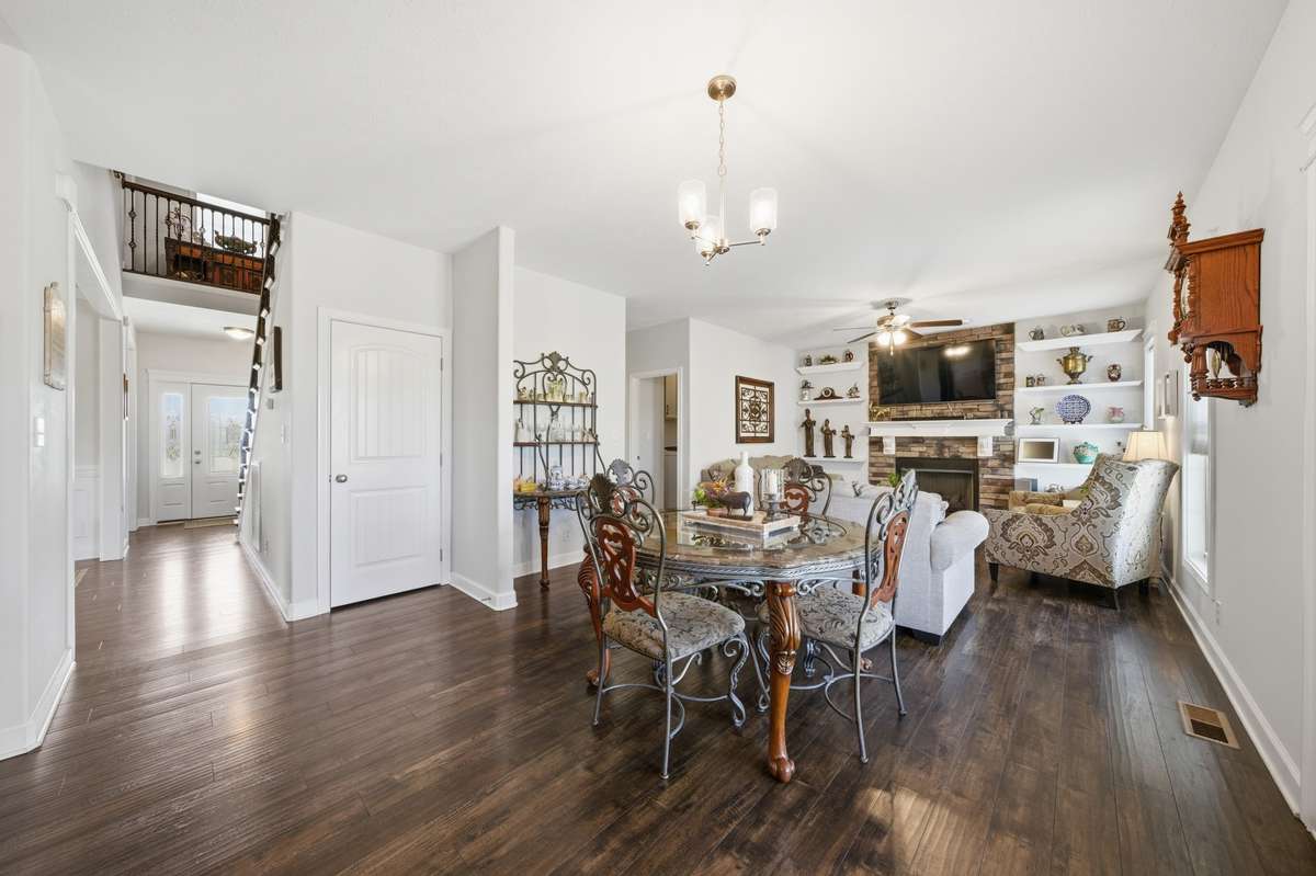 Enjoy effortless entertaining with this open dining space flowing into a cozy living room with fireplace.