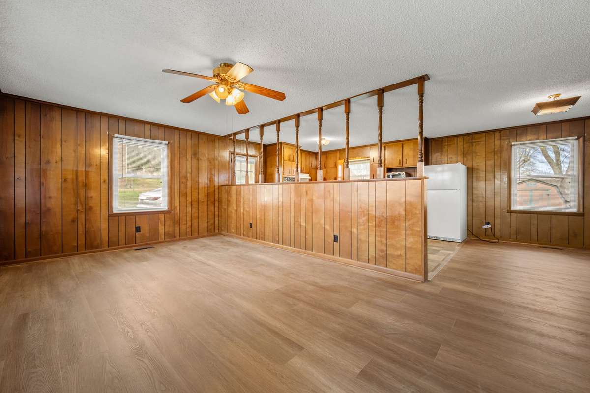View from front door into living area, new flooring and lots of character and natural light!