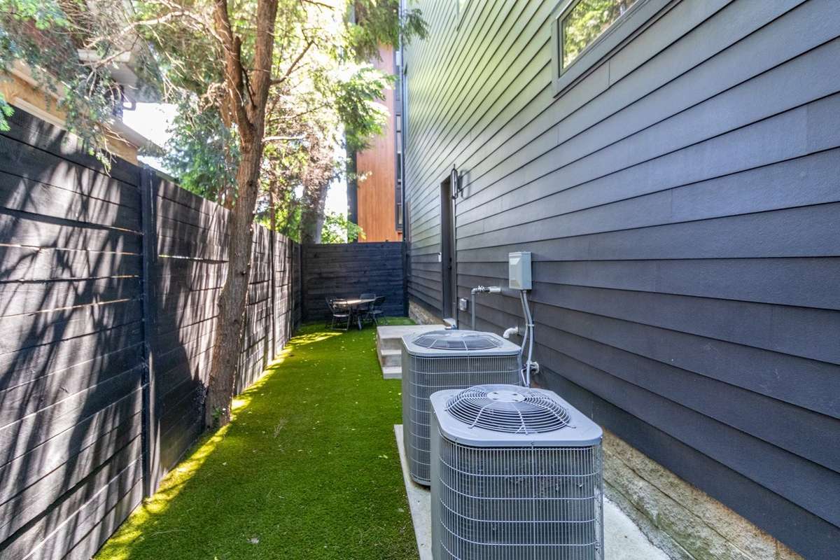 Larger view of side yard featuring 8' privacy fencing.