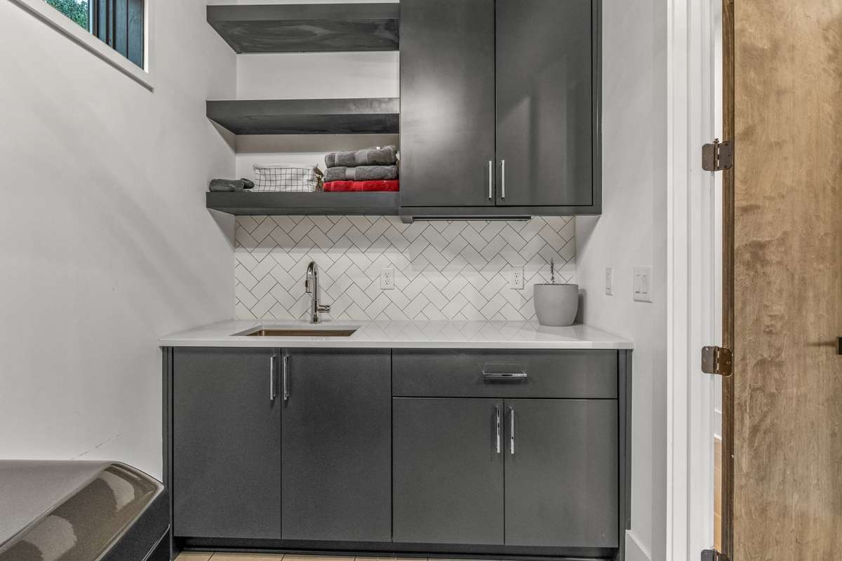 Large laundry room with built-ins plus sink on level 2