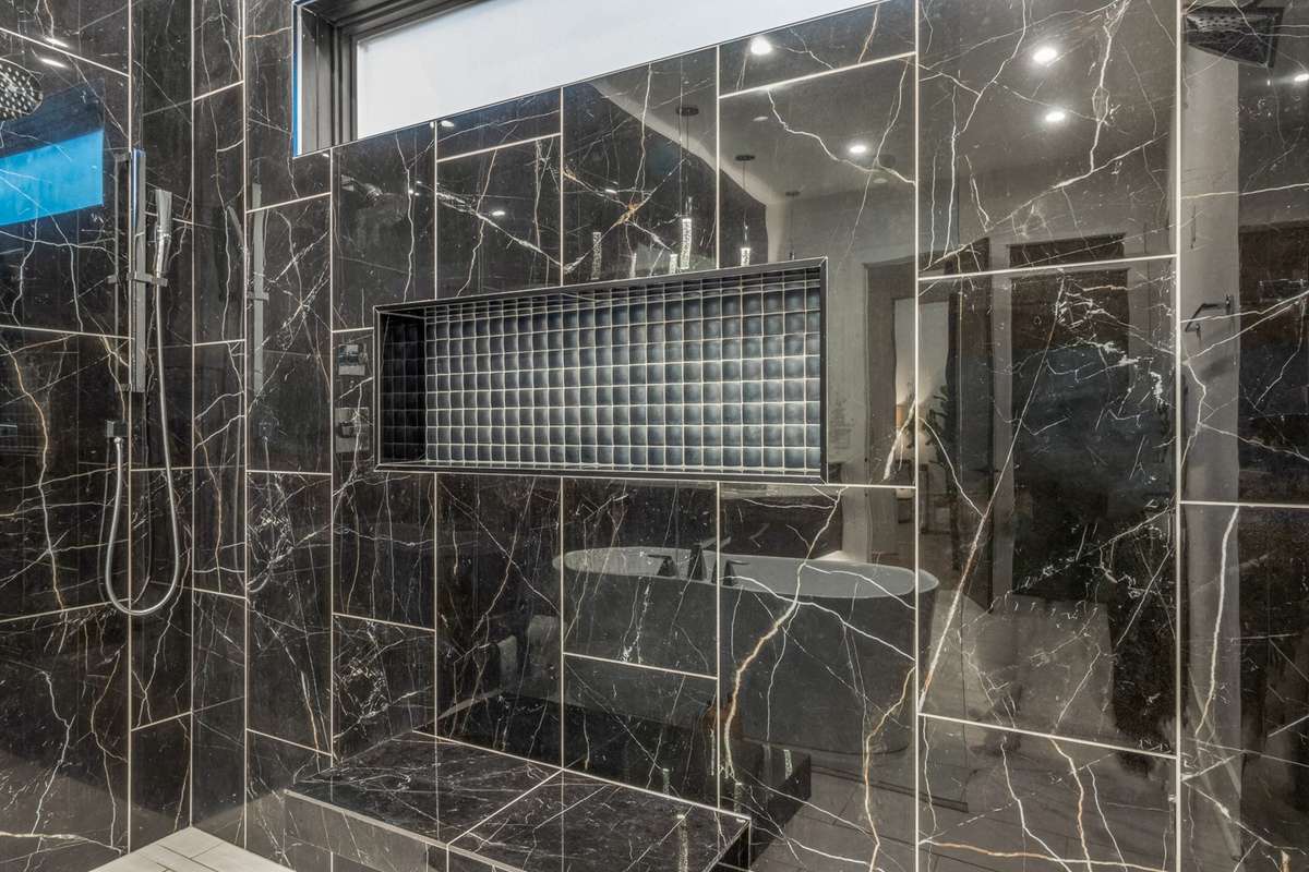 Massive designer luxurious tiled walk in shower.