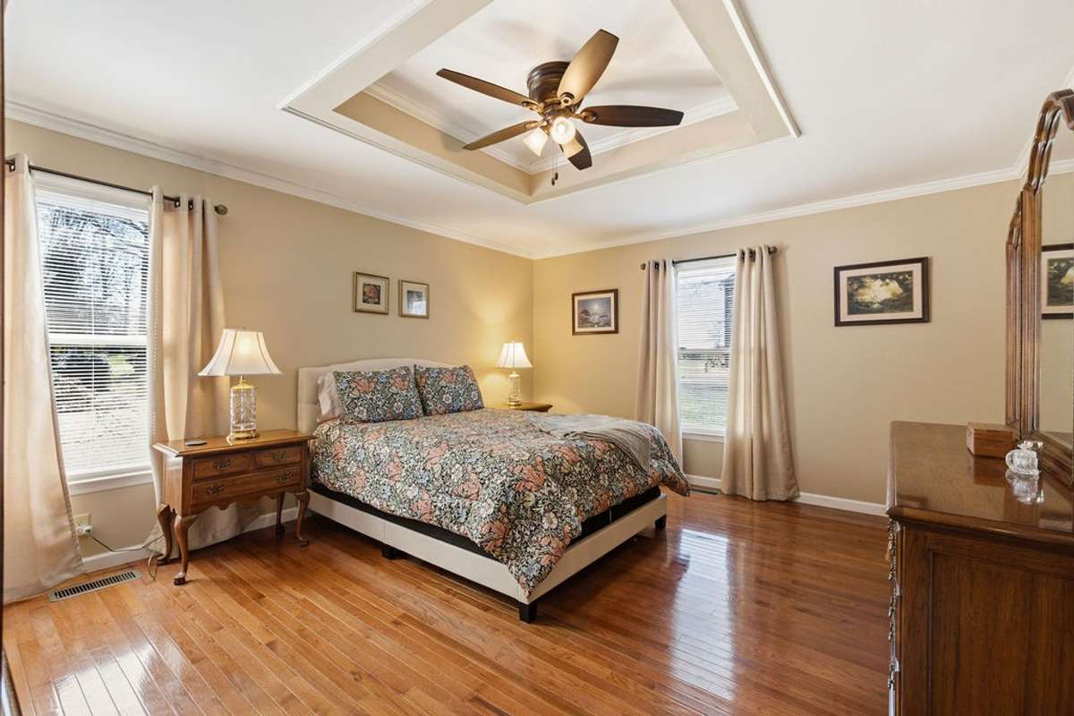 Extra large, main level Primary Bedroom with hardwood floors.