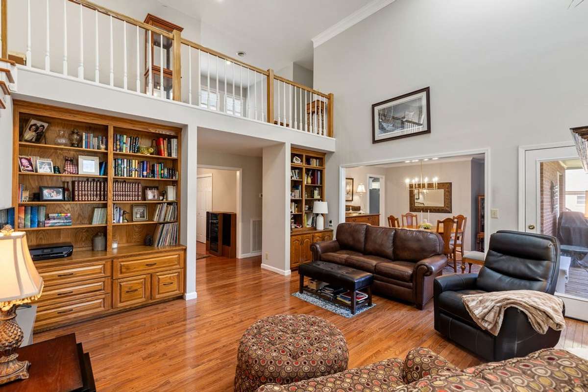 Large Great Room with built in bookcases on both sides.  Exquisite hardwood floor.