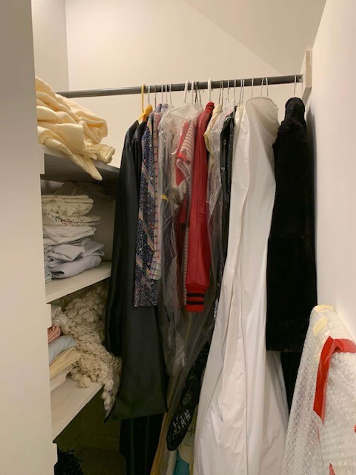This large hall walk-in closet has built-in shelving, providing ample space for organizing clothing, shoes, and accessories.